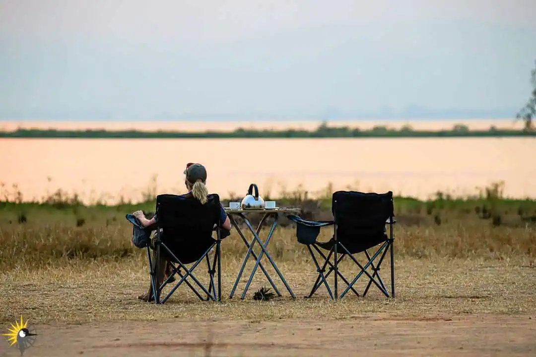 client relaxing on the shores of murchison falls